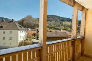 Blick von einem Balkon auf eine Stadt mit Gebäuden und Himmel im Hintergrund.