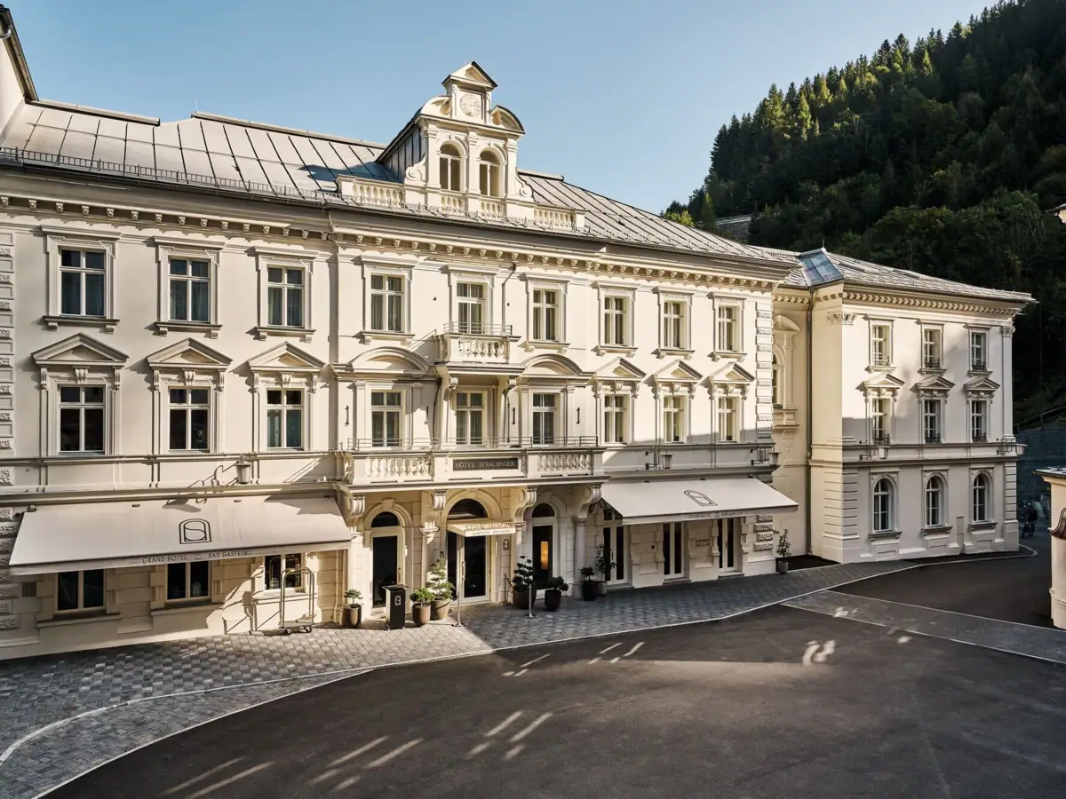 Großes weißes Gebäude mit gepflastertem Bereich.