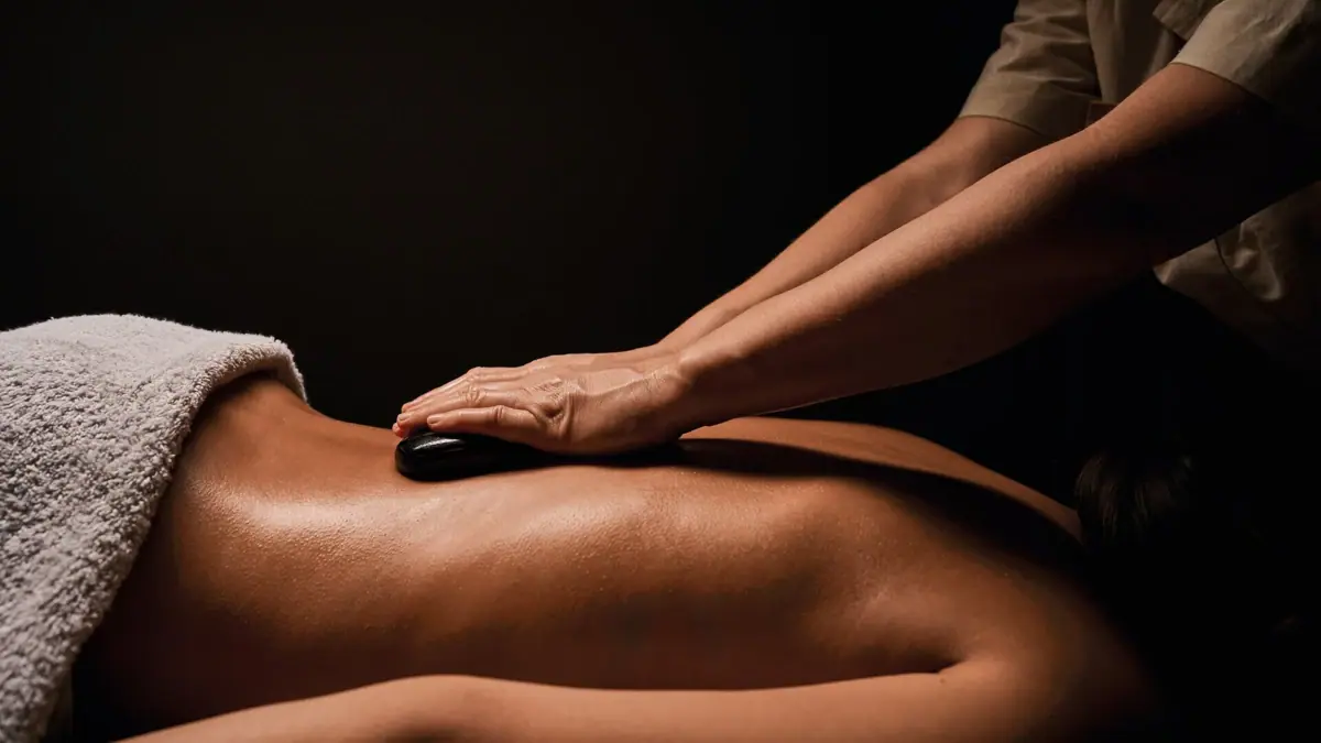 Eine Person erhält eine Hot-Stone-Massage.